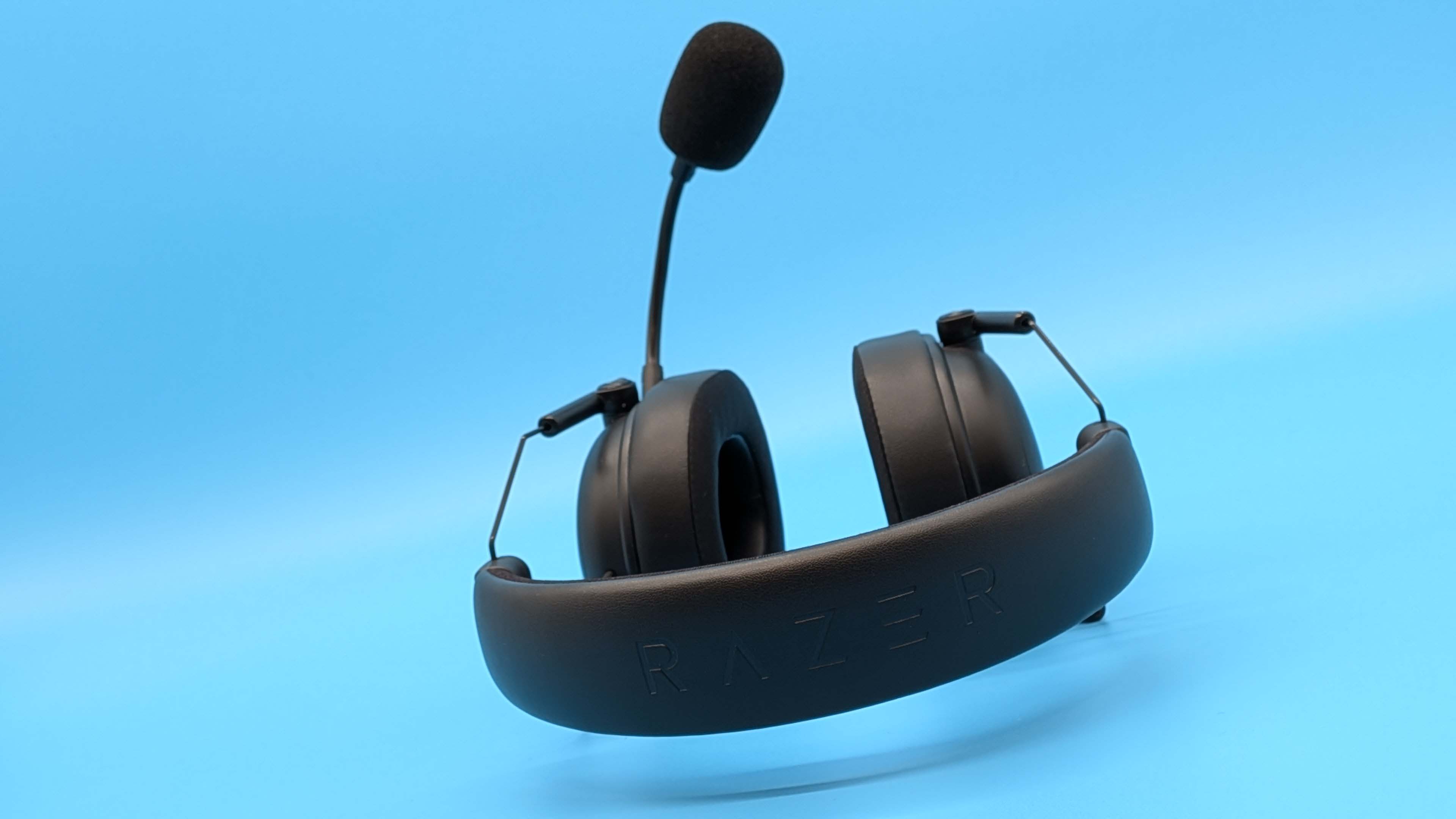 Razer BlackShark V3 gaming headset on a blue blackground