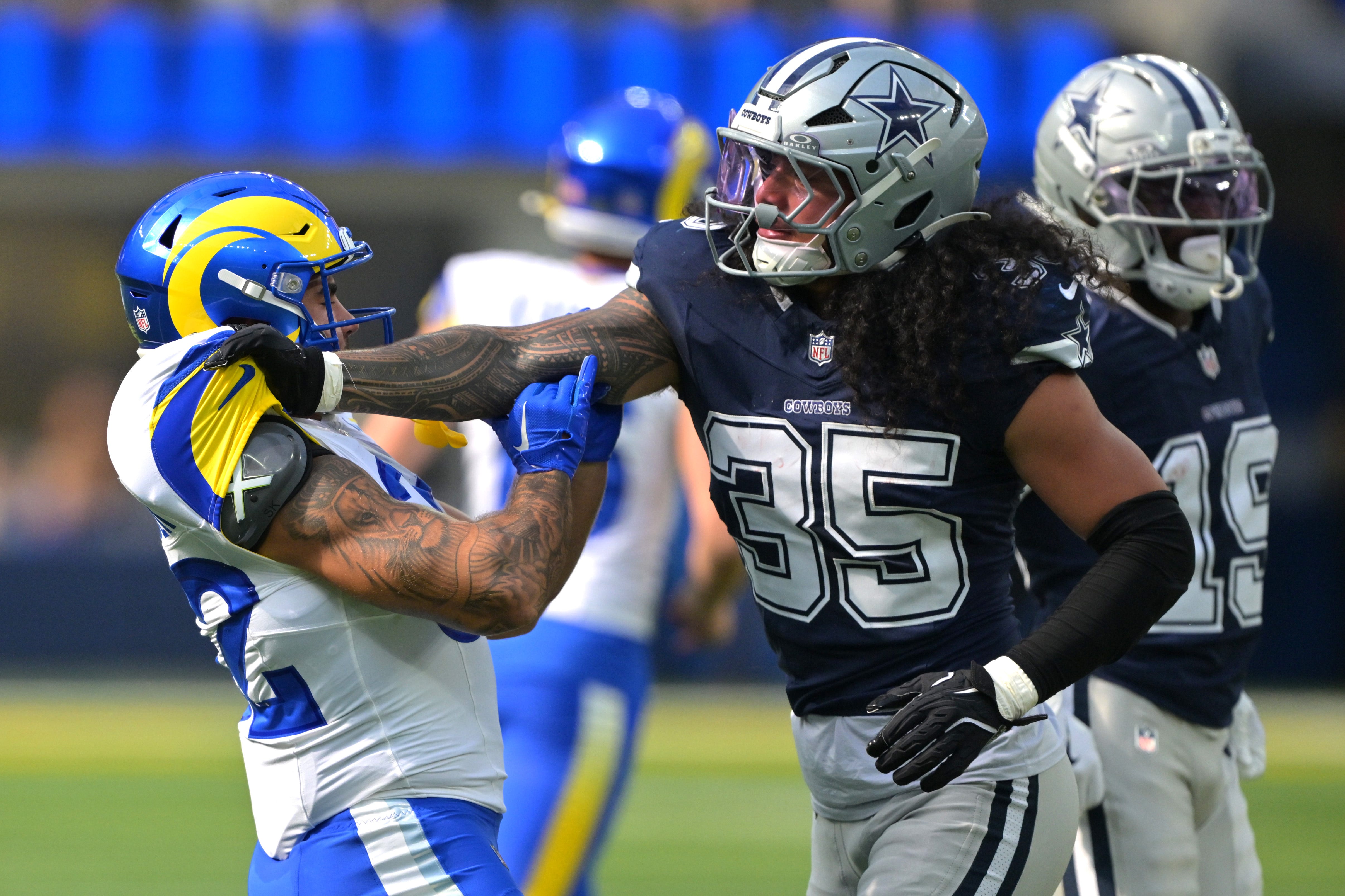 Aug 9, 2025; Inglewood, California, USA; Dallas Cowboys linebacker Marist Liufau (35) grabs a hold of Los Angeles Rams running back Cody Schrader (32) following a play inthe first half at SoFi Stadium. Mandatory Credit: Jayne Kamin-Oncea-Imagn Images