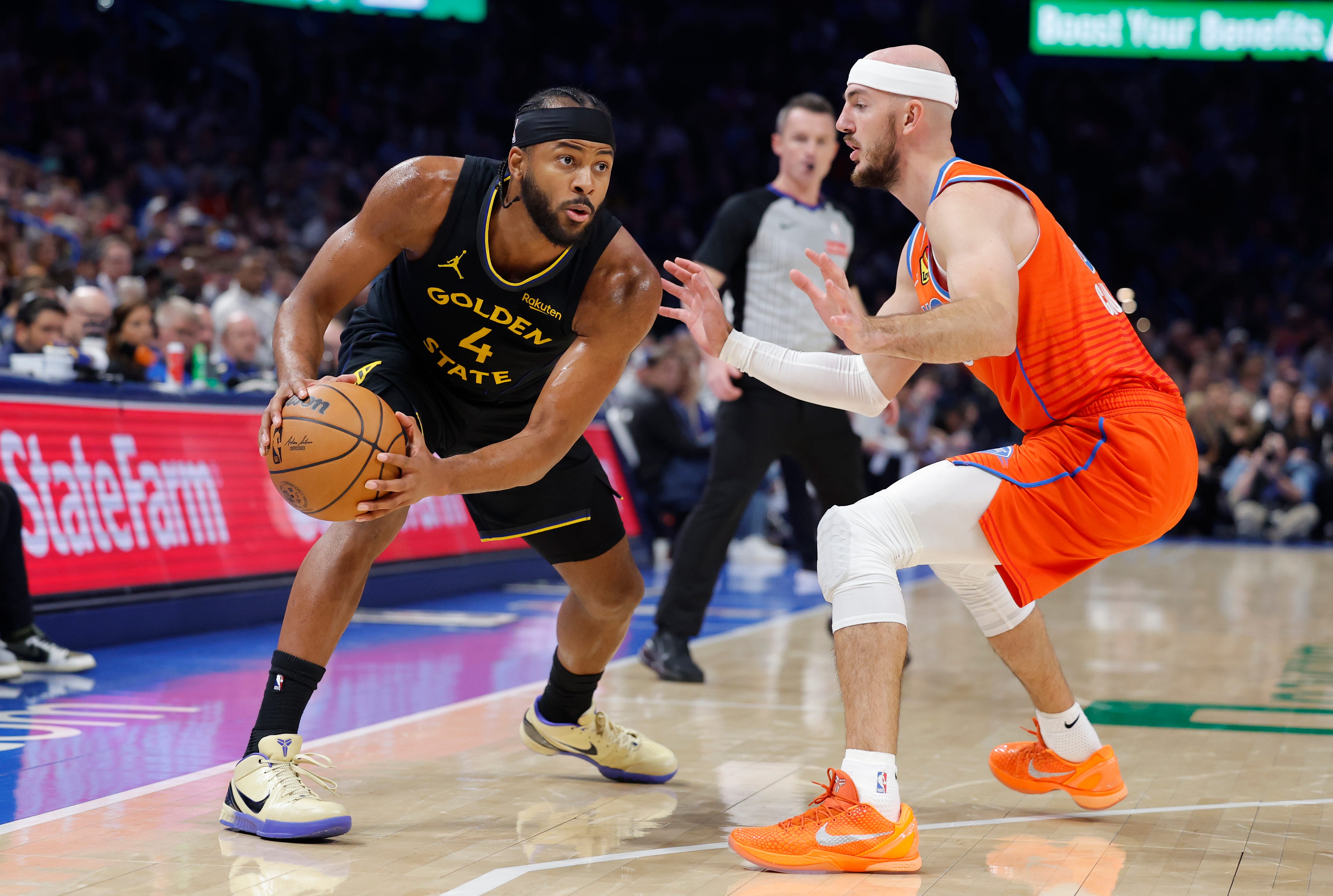 Nov 11, 2025; Oklahoma City, Oklahoma, USA; Golden State Warriors guard Moses Moody (4) is defended by Oklahoma City Thunder guard Alex Caruso (9) during the second half at Paycom Center. Mandatory Credit: Alonzo Adams-Imagn Images