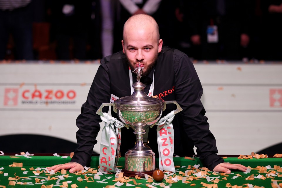 SHEFFIELD, ENGLAND - MAY 01: Luca Brecel of Belgium celebrates with the Cazoo World Snooker Championship trophy following victory in the Final match against Mark Selby of England on Day Sixteen of the Cazoo World Snooker Championship 2023 at Crucible Theatre on May 01, 2023 in Sheffield, England. (Photo by George Wood/Getty Images)