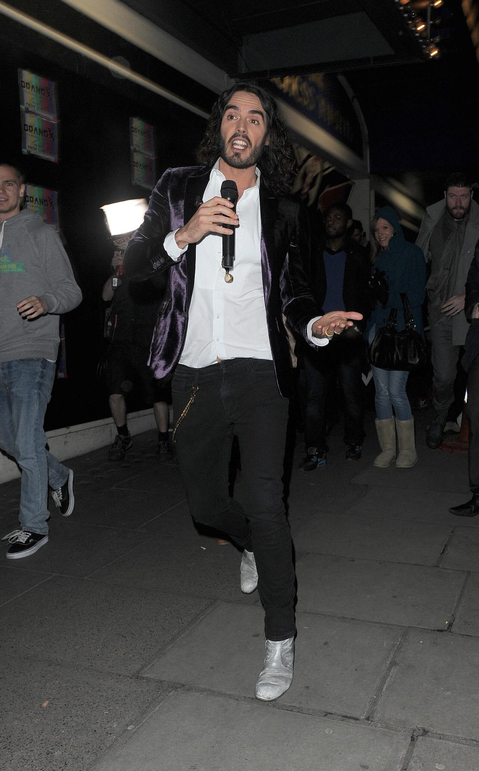 Russell Brand leaving the Duchess Theatre, having filmed his American TV show 'Brand X Live' there. The comedian wore a white shirt, black jeans, silver boots and a purple velvet blazer