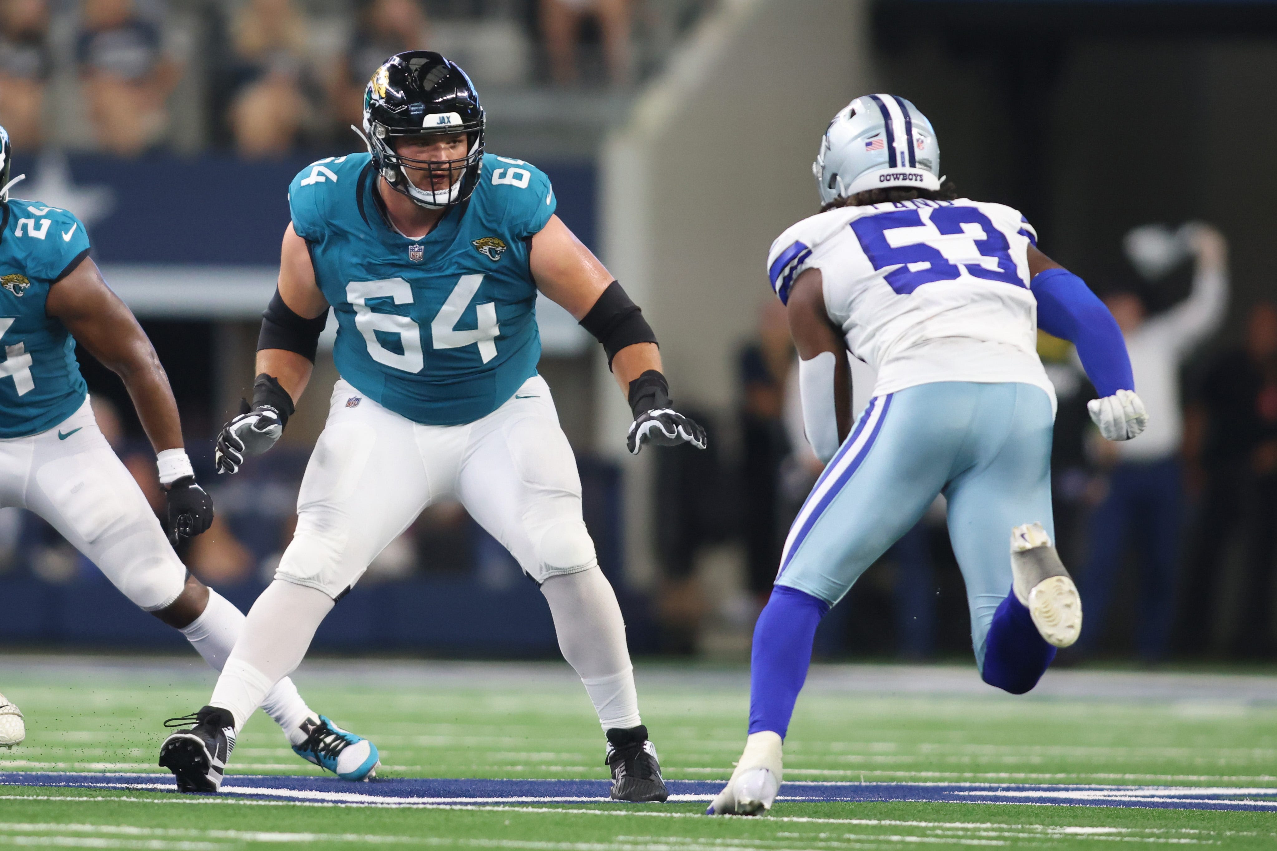 Aug 12, 2023; Arlington, Texas, USA; Jacksonville Jaguars offensive tackle Coy Cronk (64) blocks against Dallas Cowboys linebacker Isaiah Land (53) at AT&T Stadium. Mandatory Credit: Tim Heitman-USA TODAY Sports