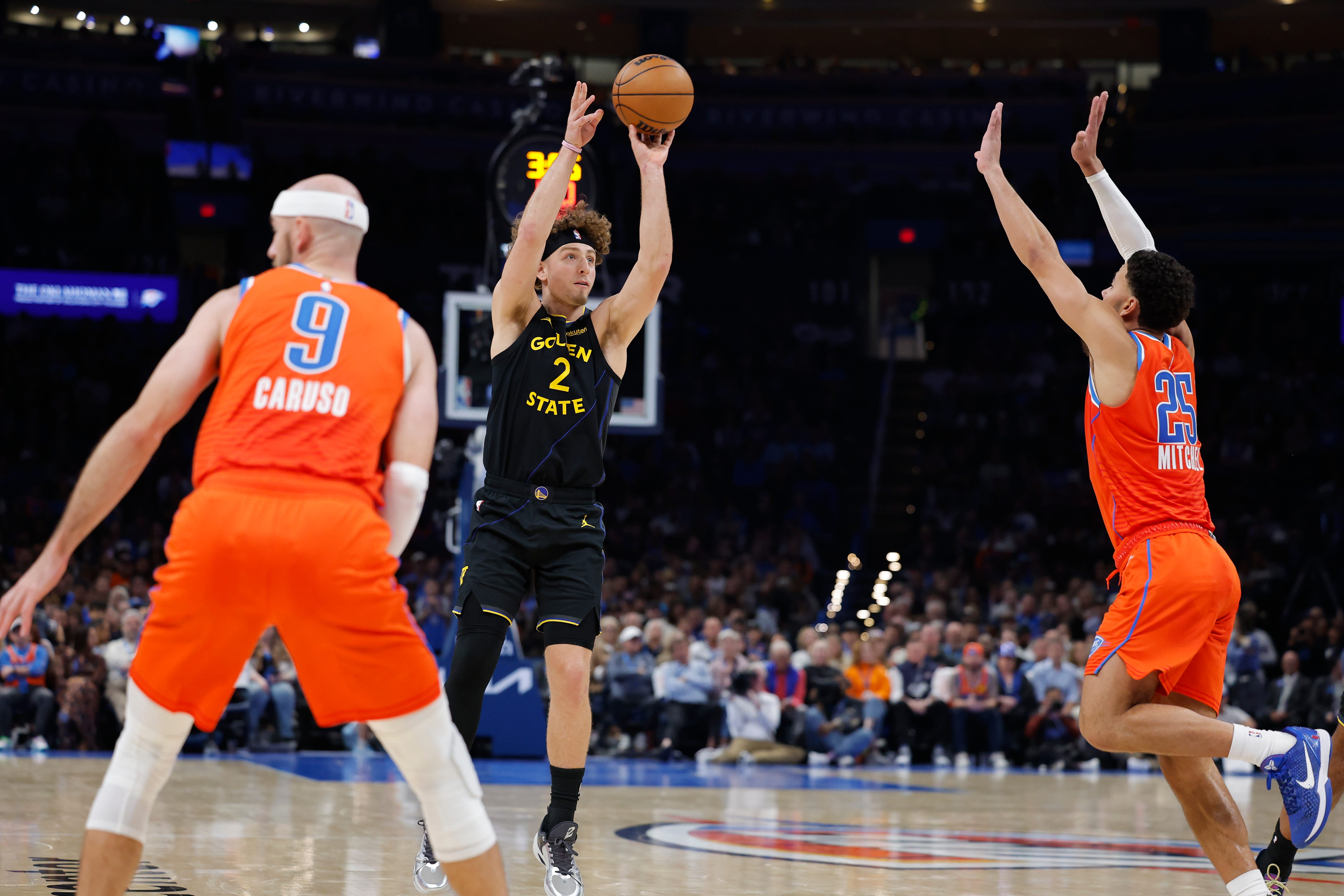 Nov 11, 2025; Oklahoma City, Oklahoma, USA; Golden State Warriors guard Brandin Podziemski (2) shoots over Oklahoma City Thunder guard Ajay Mitchell (25) during the second half at Paycom Center. Mandatory Credit: Alonzo Adams-Imagn Images