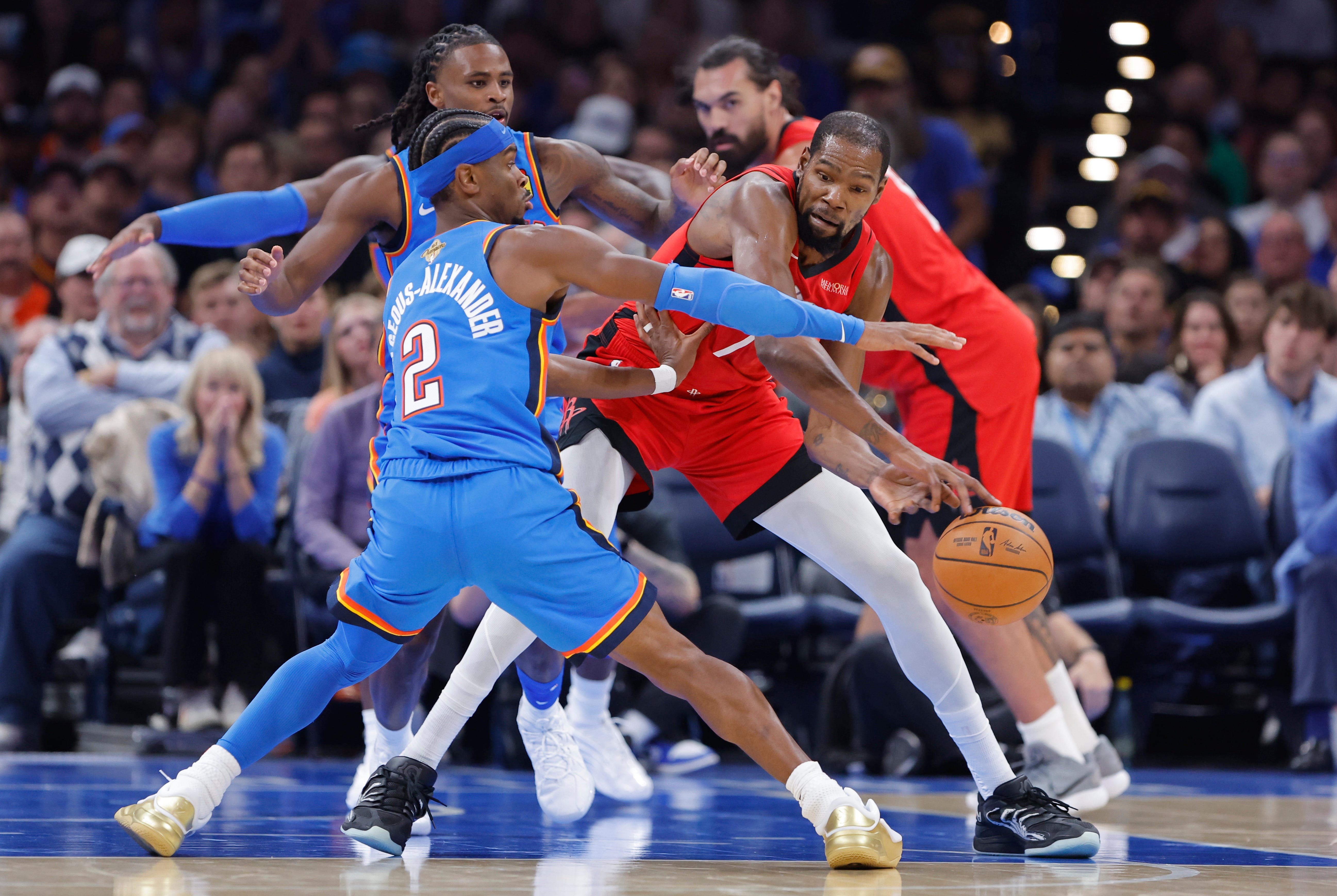 Oct 21, 2025; Oklahoma City, Oklahoma, USA; Houston Rockets forward Kevin Durant (7) passes around Oklahoma City Thunder guard Shai Gilgeous-Alexander (2) during the first half at Paycom Center. Mandatory Credit: Alonzo Adams-Imagn Images