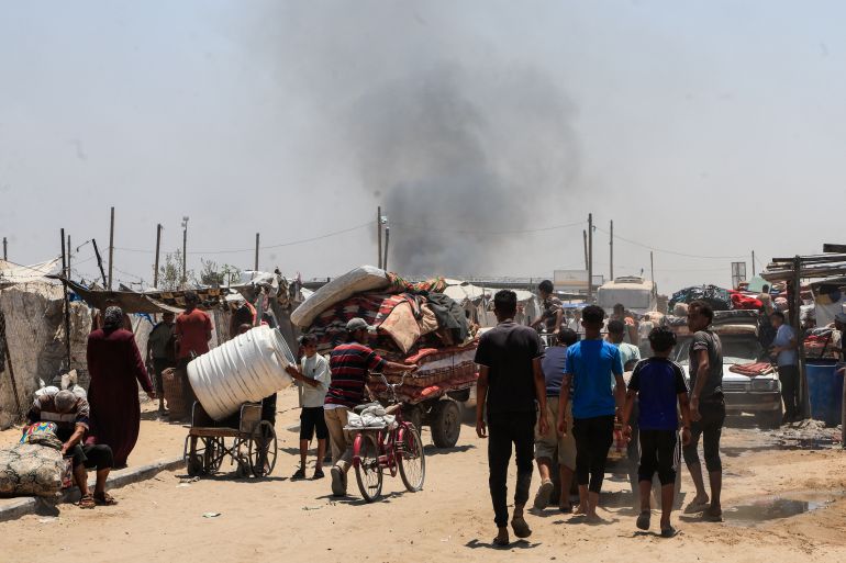 Smoke rises after an Israeli strike as displaced Palestinians make their way towards Mawasi area as they flee amid an Israeli ground offensive, in Khan Younis in the southern Gaza Strip July 10, 2025. REUTERS/Hatem Khaled