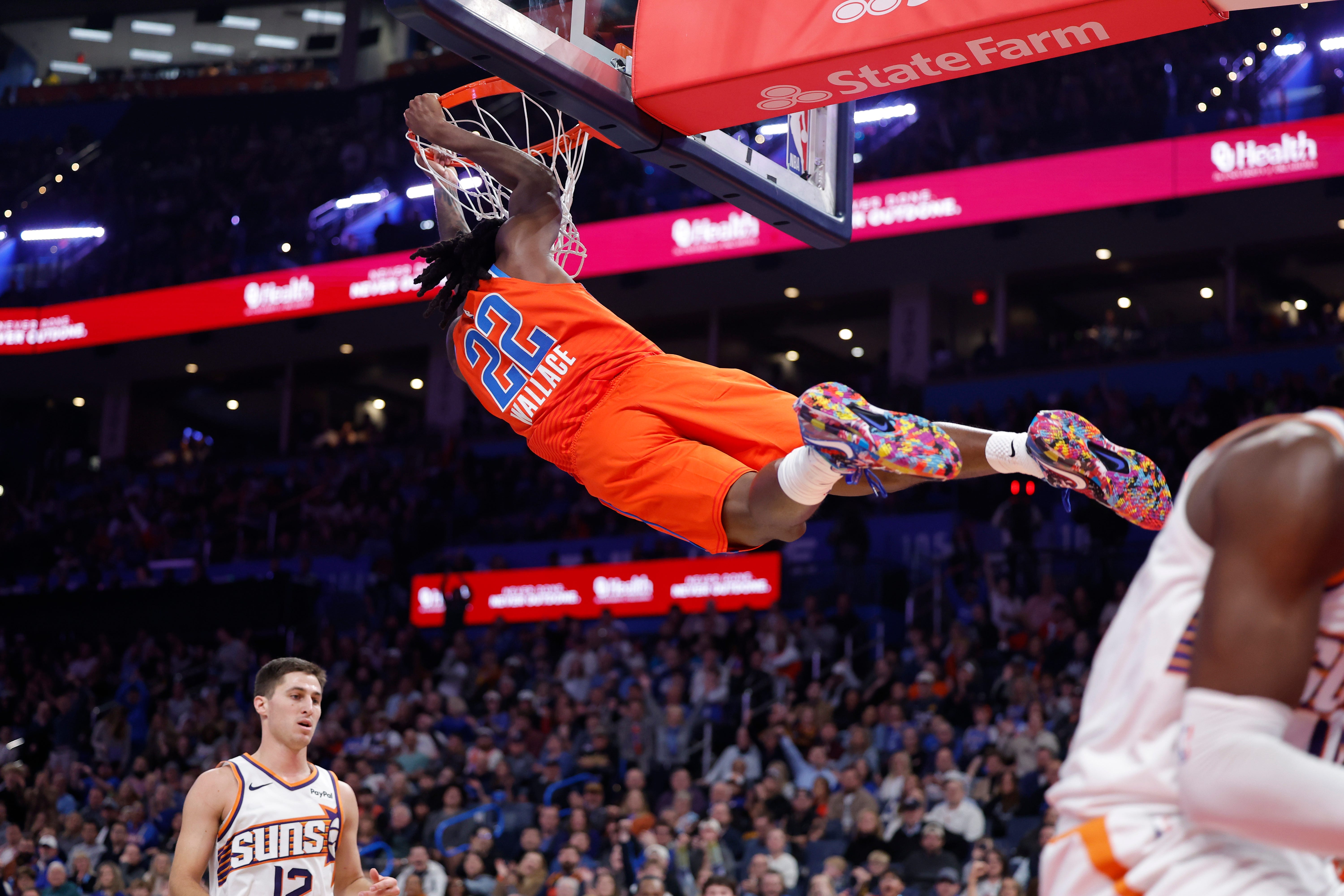 Nov 28, 2025; Oklahoma City, Oklahoma, USA; Oklahoma City Thunder guard Cason Wallace (22) dunks against the Phoenix Suns during the second half at Paycom Center. Mandatory Credit: Alonzo Adams-Imagn Images
