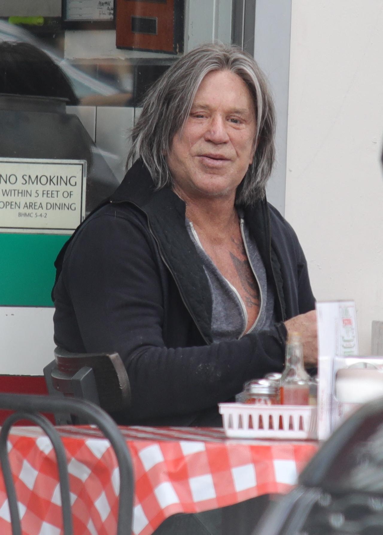 Mickey Rourke seen with long locks in new hairstyle.