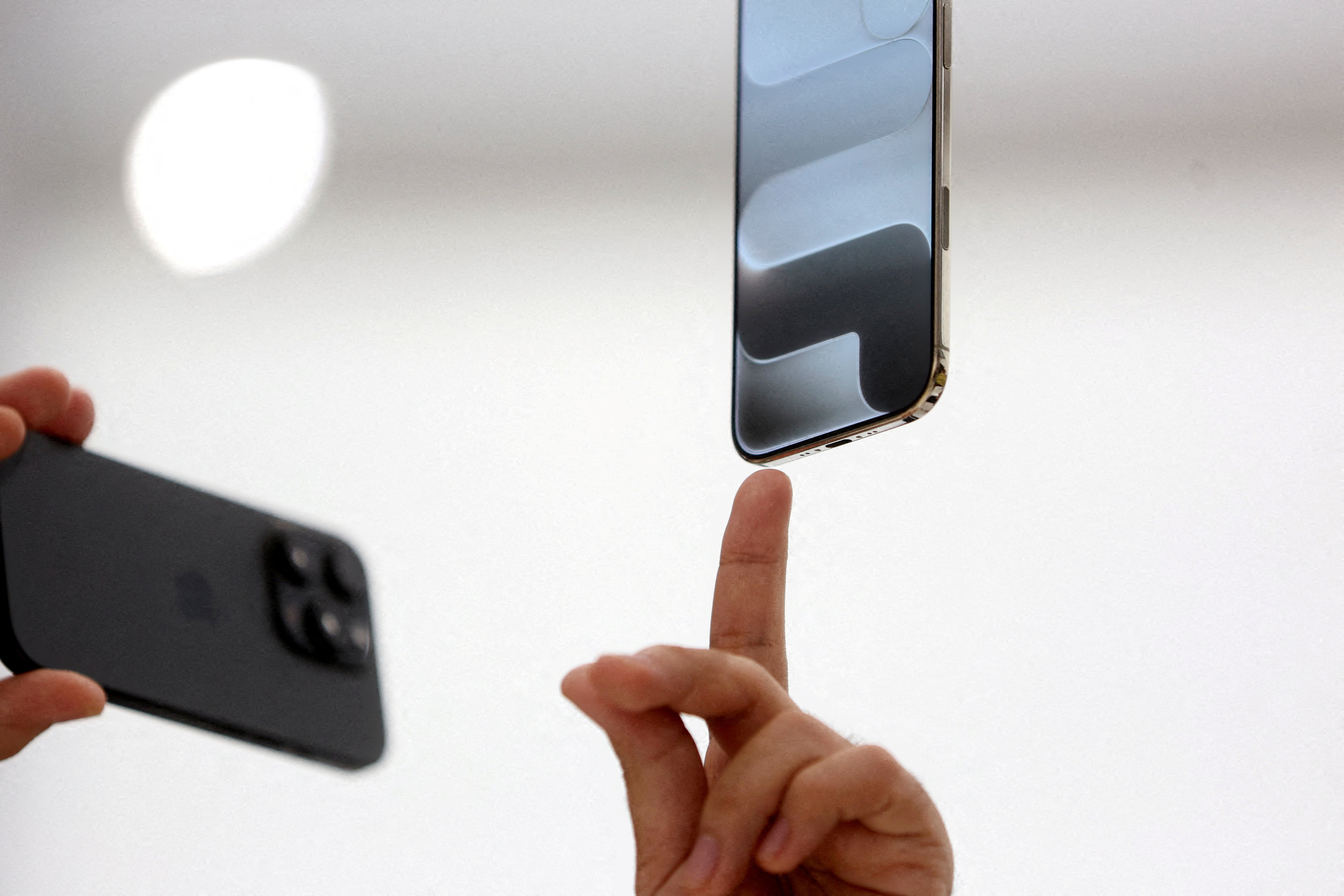 A person points to an iPhone during Apple's event at the Steve Jobs Theater on its campus in Cupertino, California, U.S. September 9, 2025. REUTERS/Manuel Orbegozo TPX IMAGES OF THE DAY