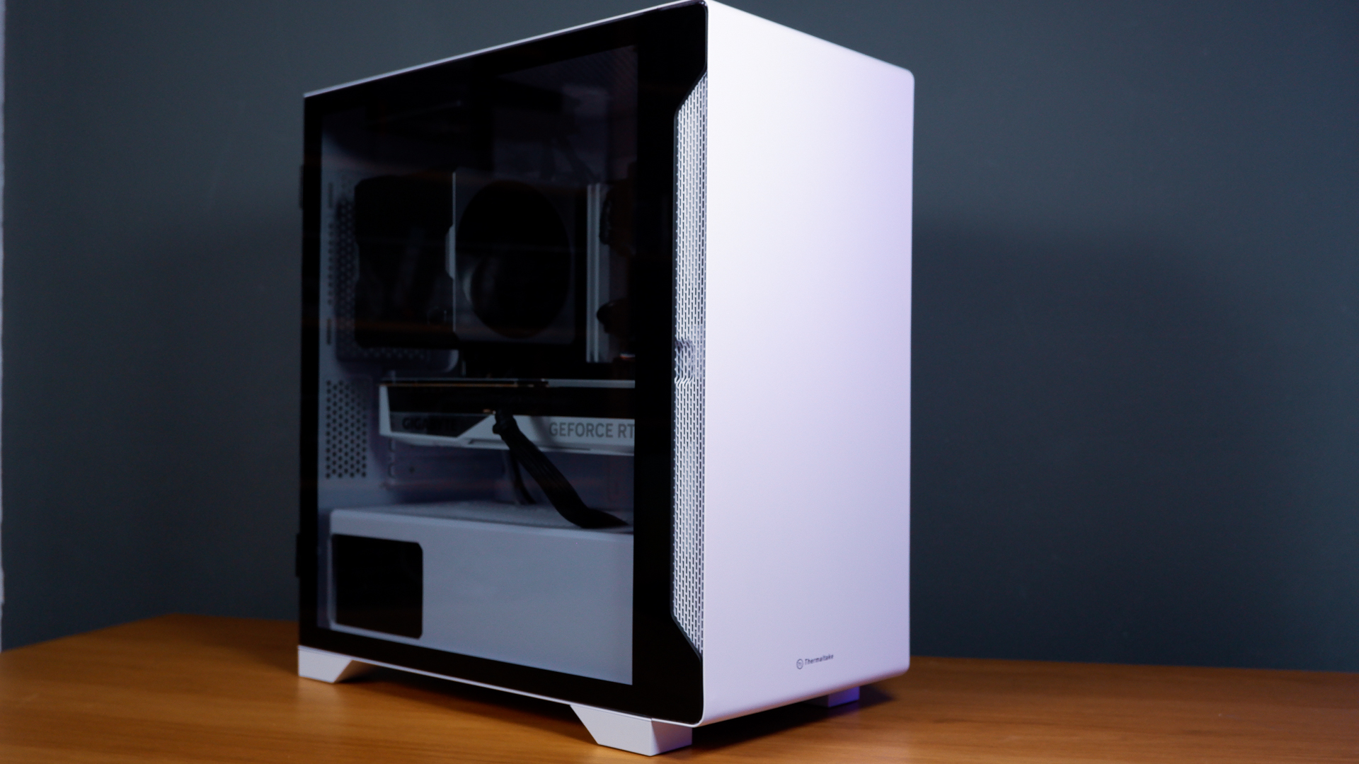 A white gaming PC built using a Thermaltake PC case, Cooler Master fans, and an AMD CPU.