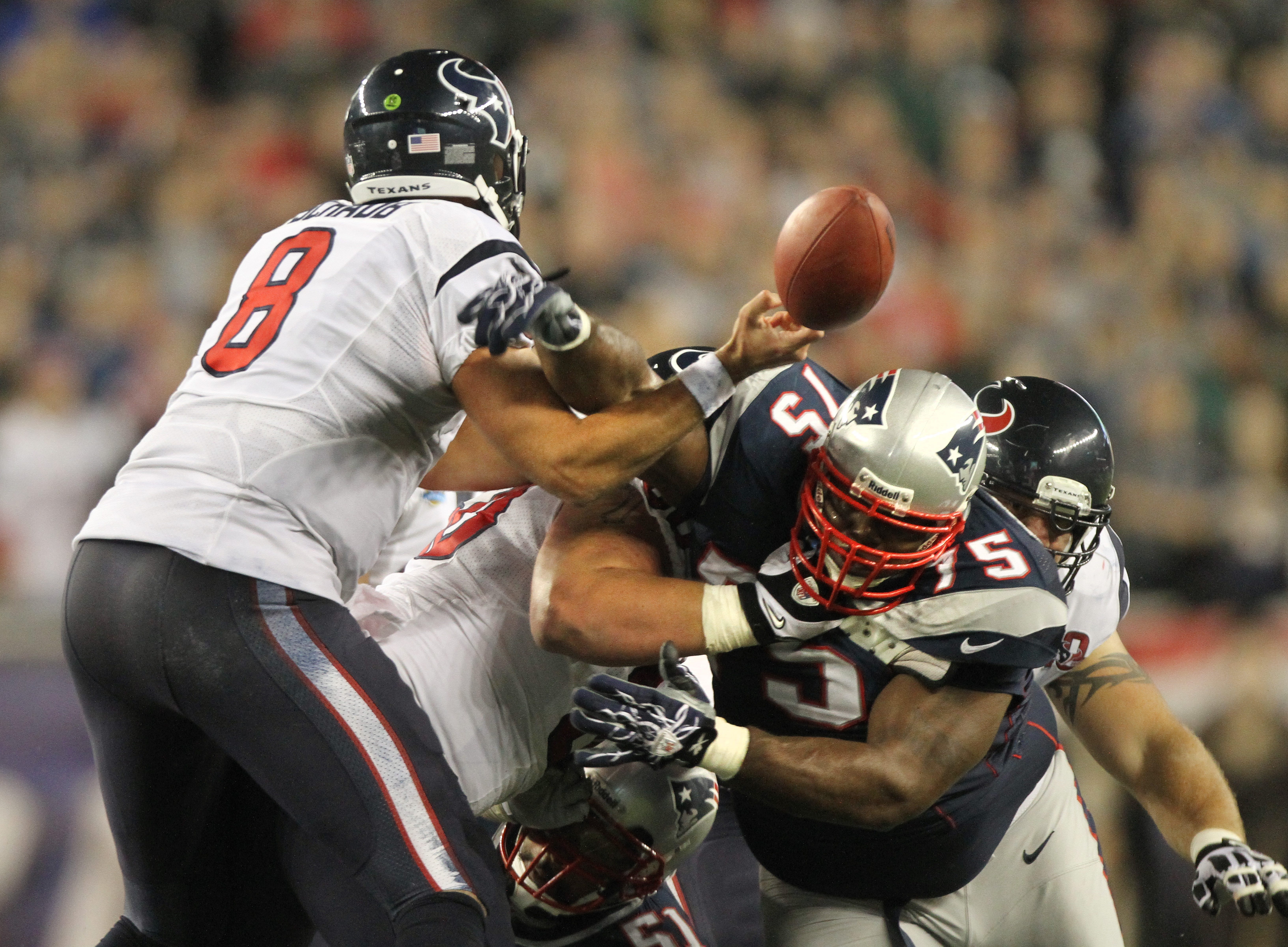 Patriot defender Vince Wilfork forces a fumble by Houston quarterback Matt Schaub.