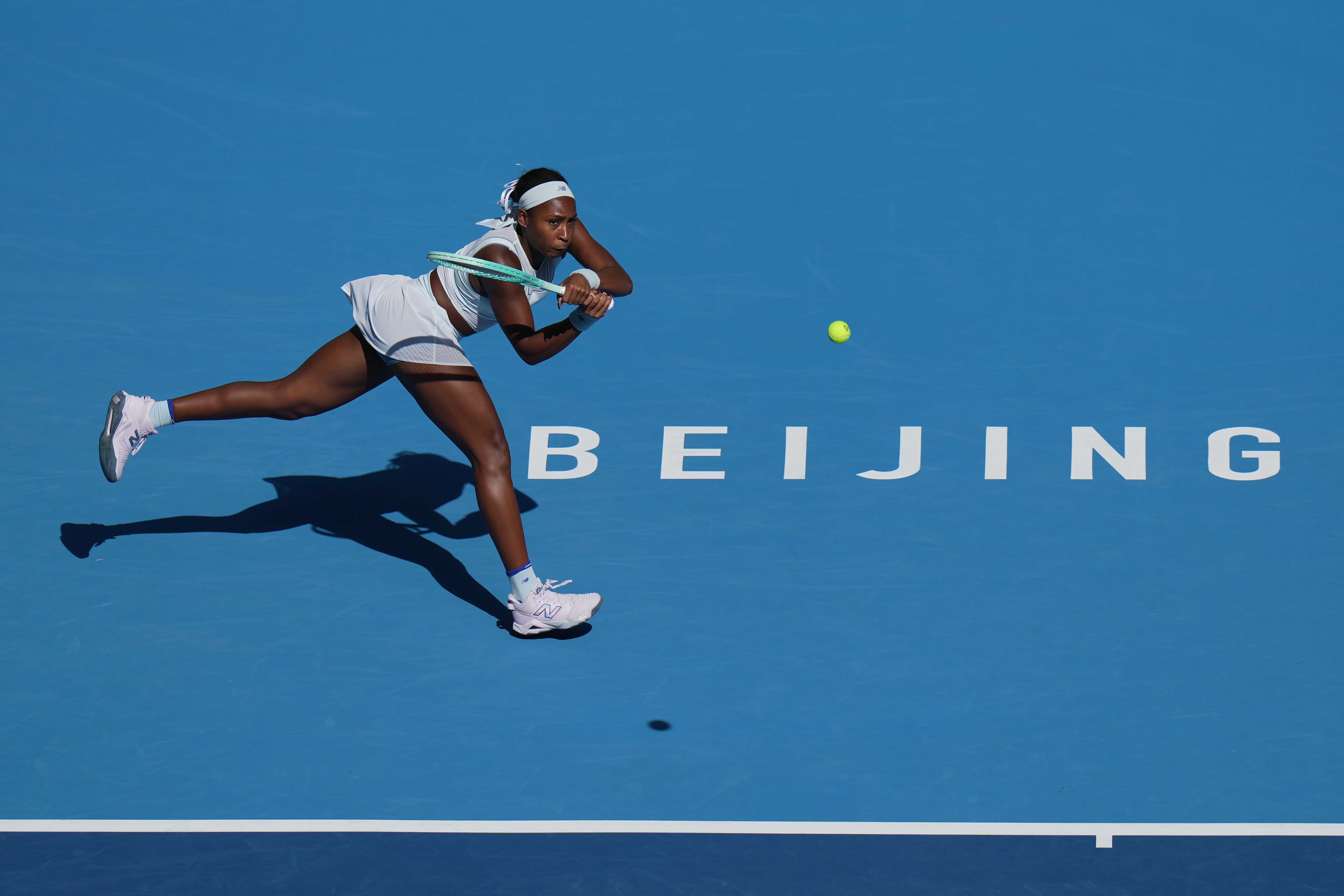 Coco Gauff, of the United States plays a backhand return to Belinda Bencic, of Switzerland during the women's singles match of the China Open tennis tournament, in Beijing, Tuesday, Sept. 30, 2025. (AP Photo/Andy Wong)