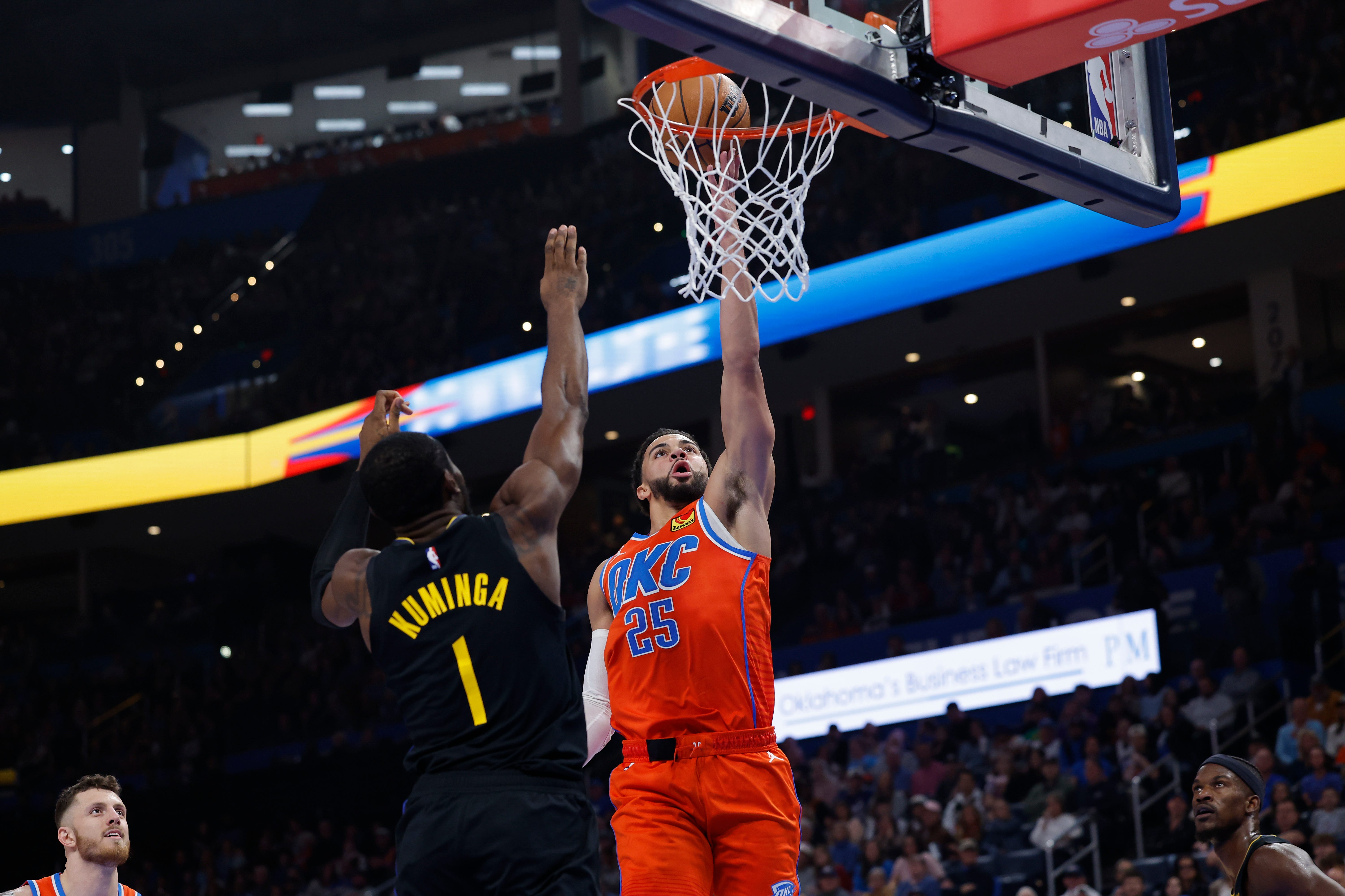 Nov 11, 2025; Oklahoma City, Oklahoma, USA; Oklahoma City Thunder guard Ajay Mitchell (25) goes up for a basket in front of Golden State Warriors forward Jonathan Kuminga (1) during the second quarter at Paycom Center. Mandatory Credit: Alonzo Adams-Imagn Images