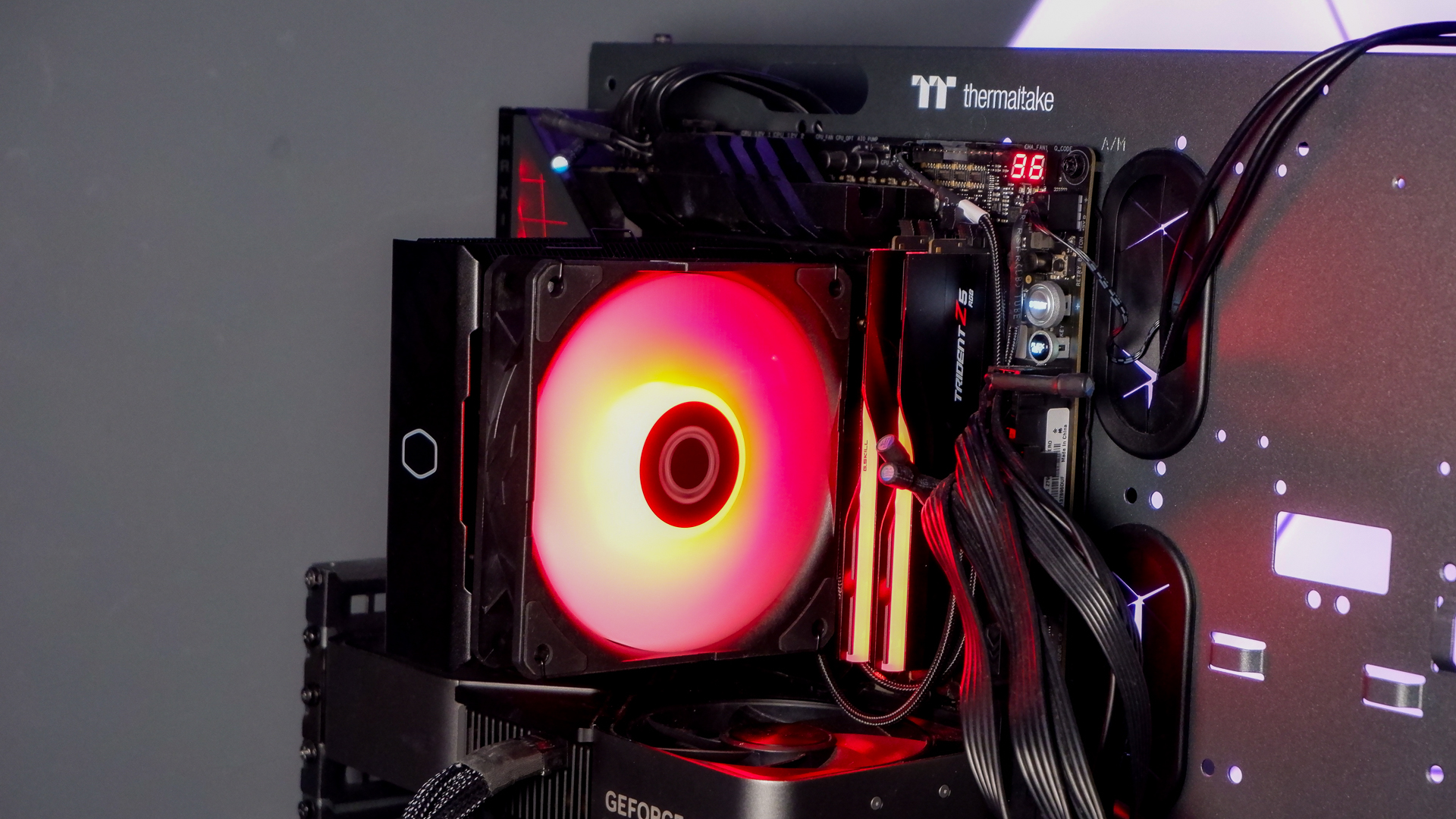 A Cooler Master Hyper 212 Pro air cooler with its packaging and installed on a gaming PC.