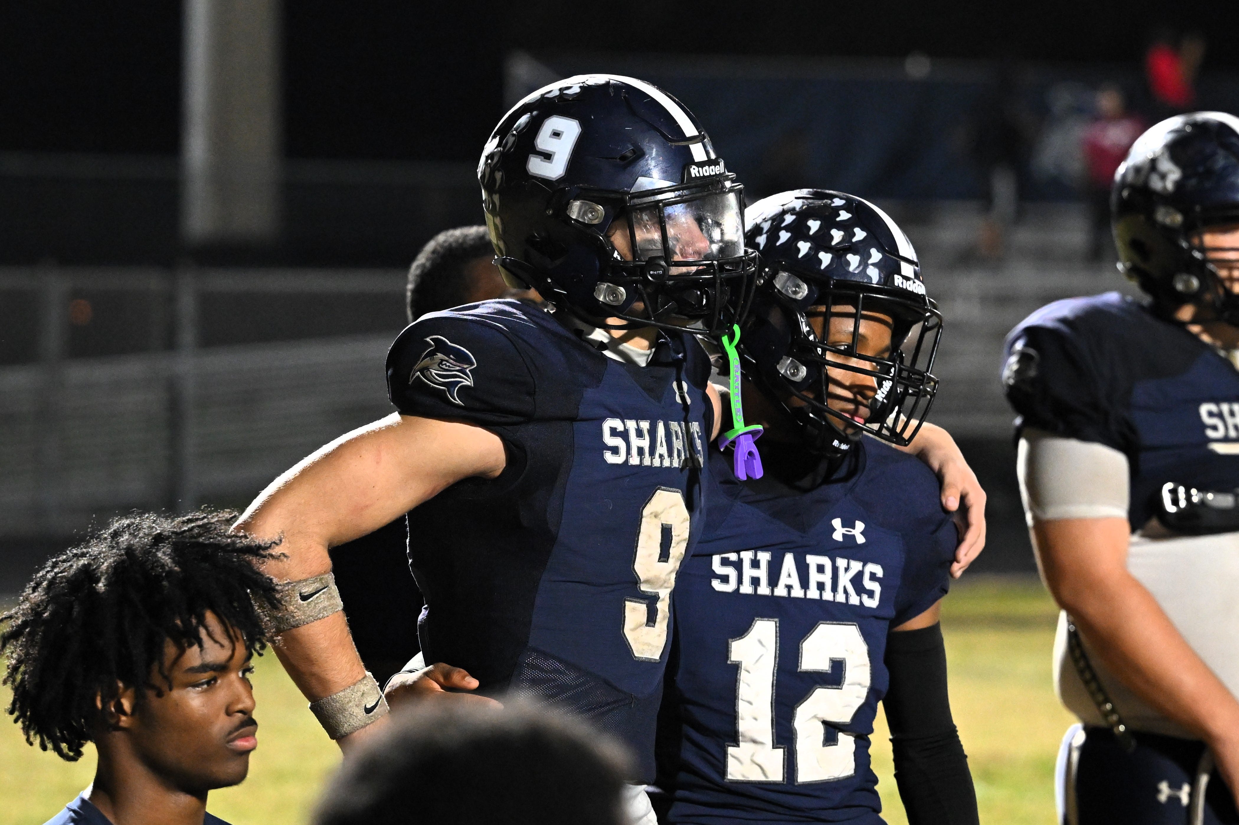 Spanish River's Ben Lamas and Timothy Shedrick listen to head coach Nick LaSala's prideful postgame speech following a regional semifinals loss to Goleman on Nov. 21, 2025.
