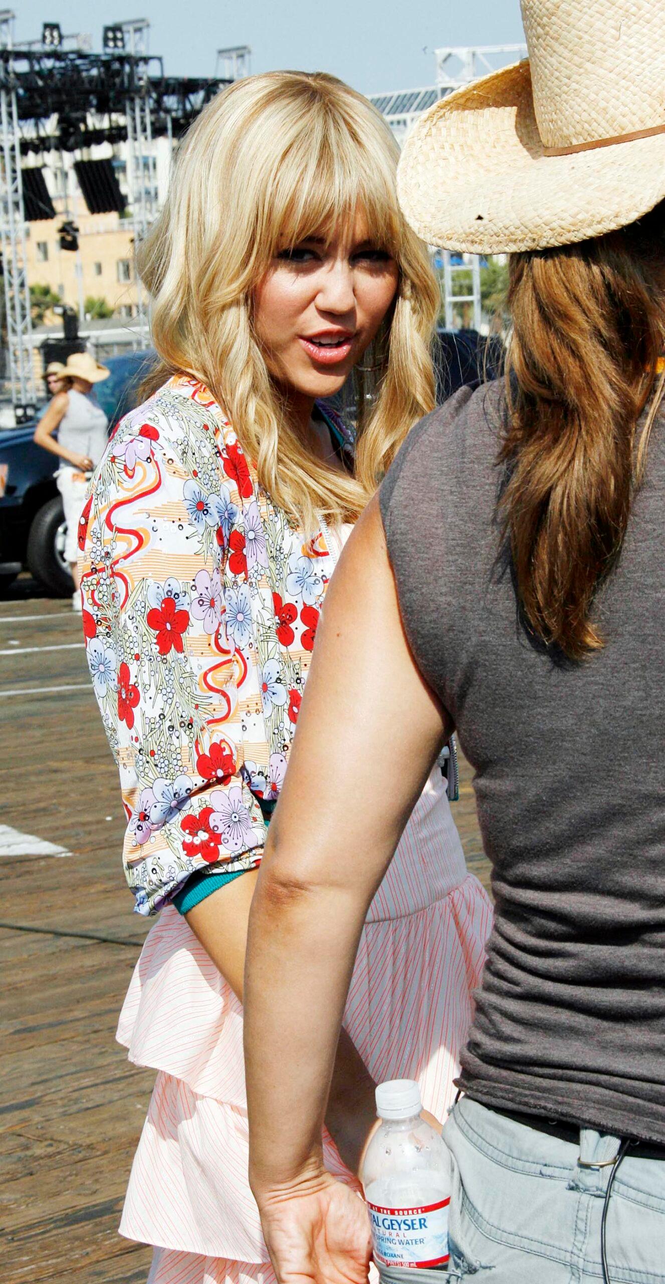 Miley Cyrus as Hannah Montana. 