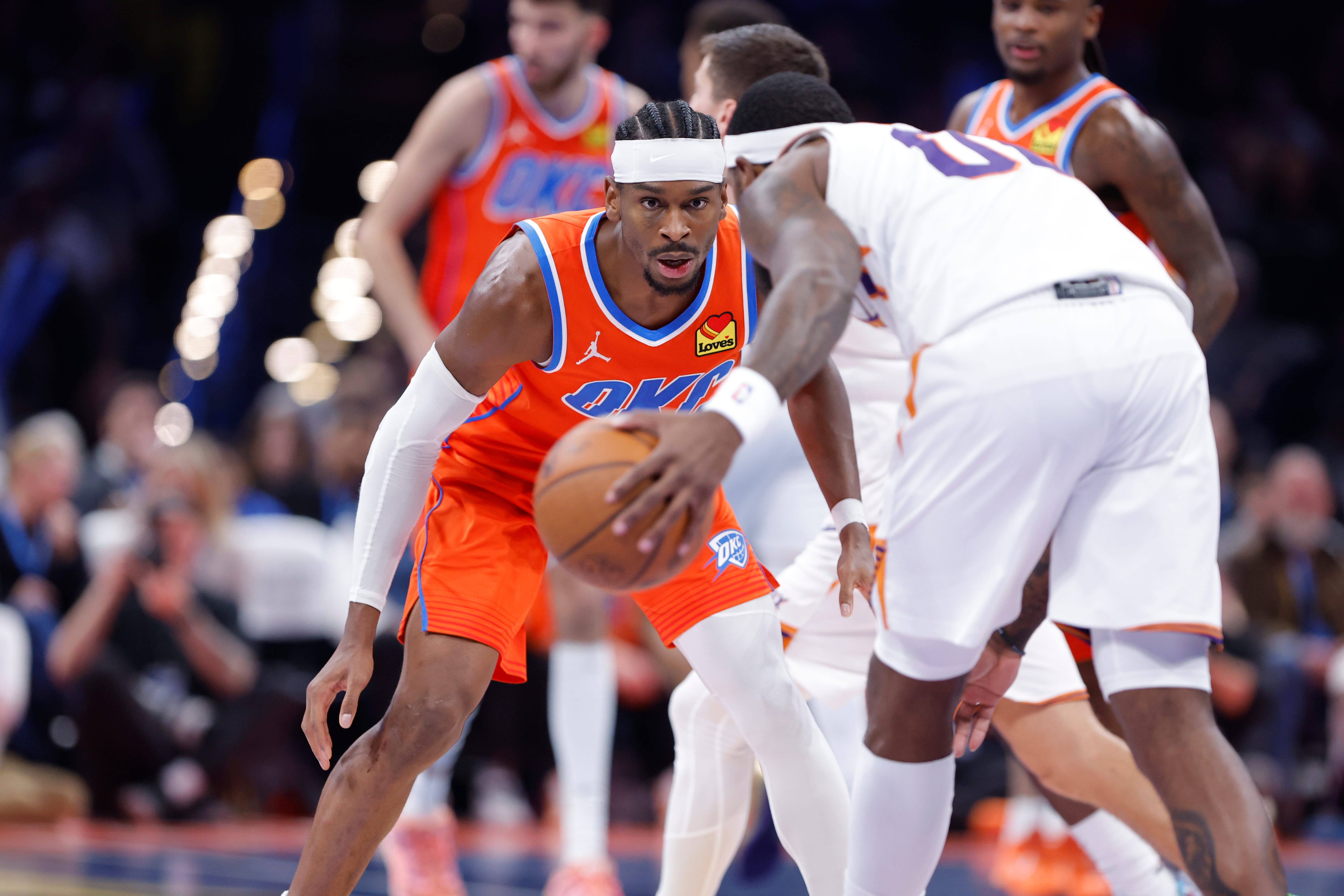 Nov 28, 2025; Oklahoma City, Oklahoma, USA; Oklahoma City Thunder guard Shai Gilgeous-Alexander (2) defends a drive by Phoenix Suns forward Royce O'Neale (00) during the second half at Paycom Center. Mandatory Credit: Alonzo Adams-Imagn Images