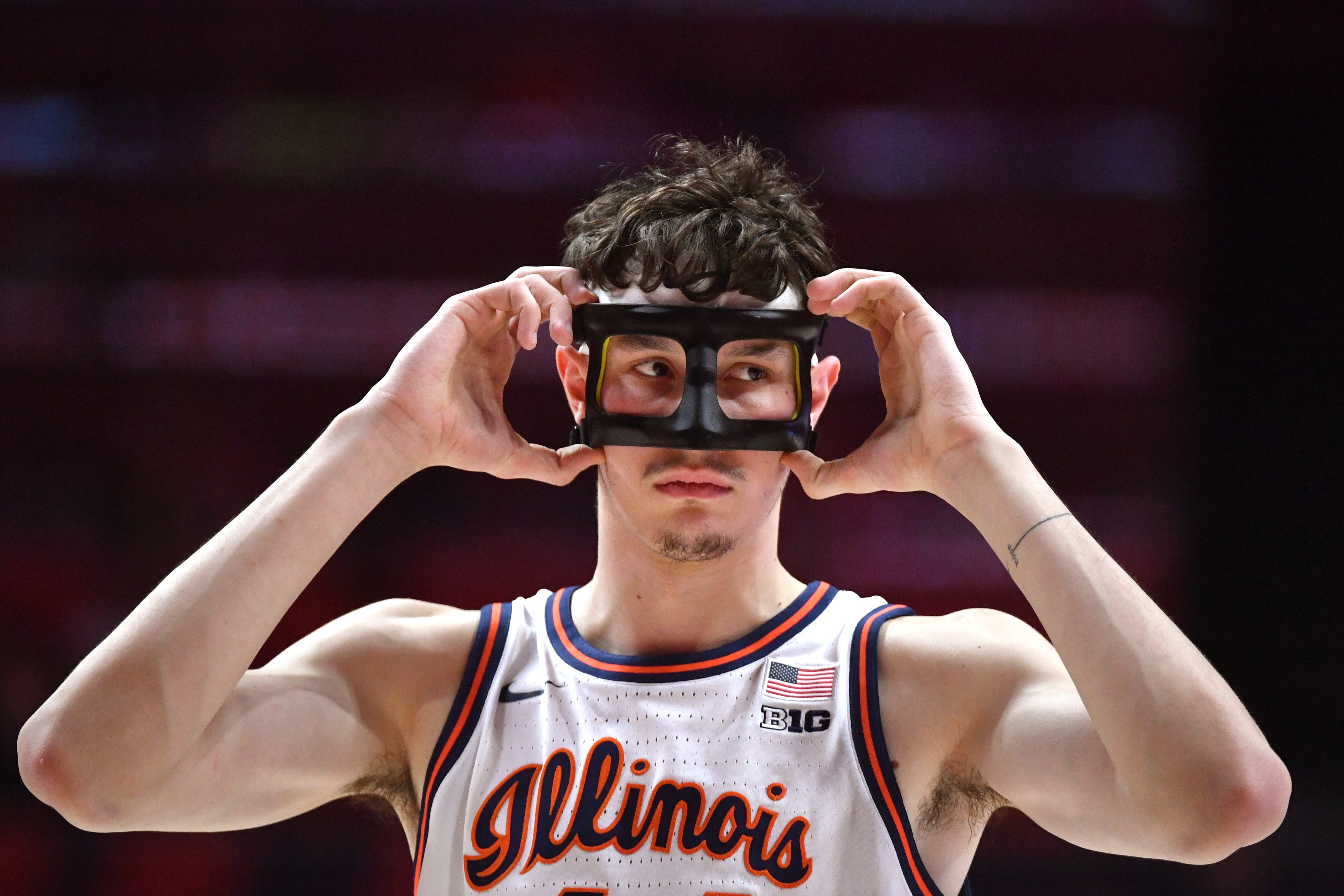 Jan 8, 2026; Champaign, Illinois, USA; Illinois Fighting Illini forward Zvonimir Ivisic (44) adjusts his protective mask during the first half against the Rutgers Scarlet Knights at State Farm Center. Mandatory Credit: Ron Johnson-Imagn Images