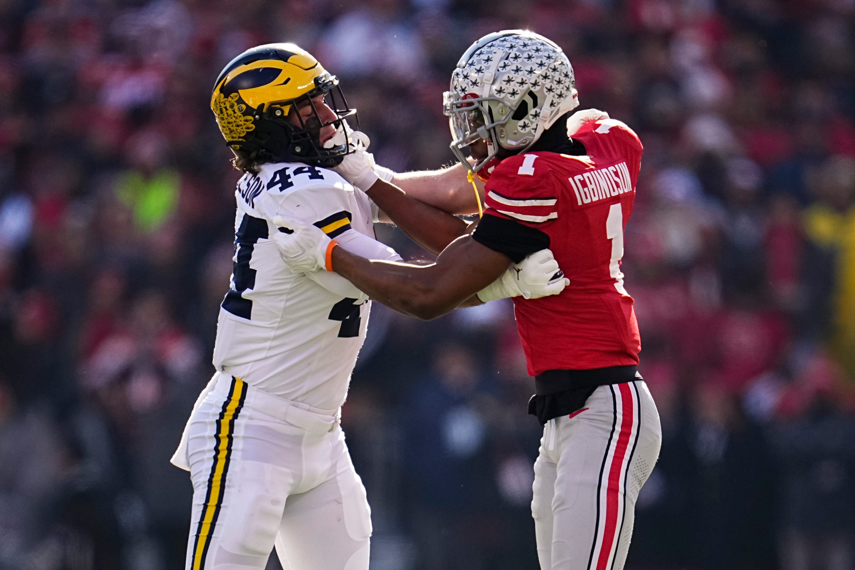 Ohio State Buckeyes cornerback Davison Igbinosun (1) locks up with Michigan Wolverines tight end Max Bredeson (44) during the NCAA football game at Ohio Stadium in Columbus on Tuesday, Dec. 3, 2024. Michigan won 13-10.