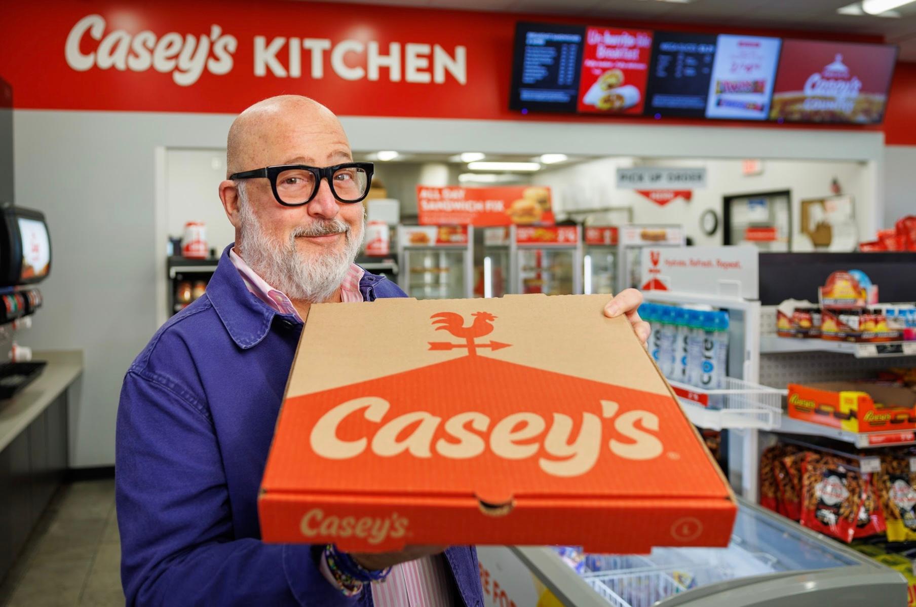 Andrew Zimmern holding Casey's pizza box
