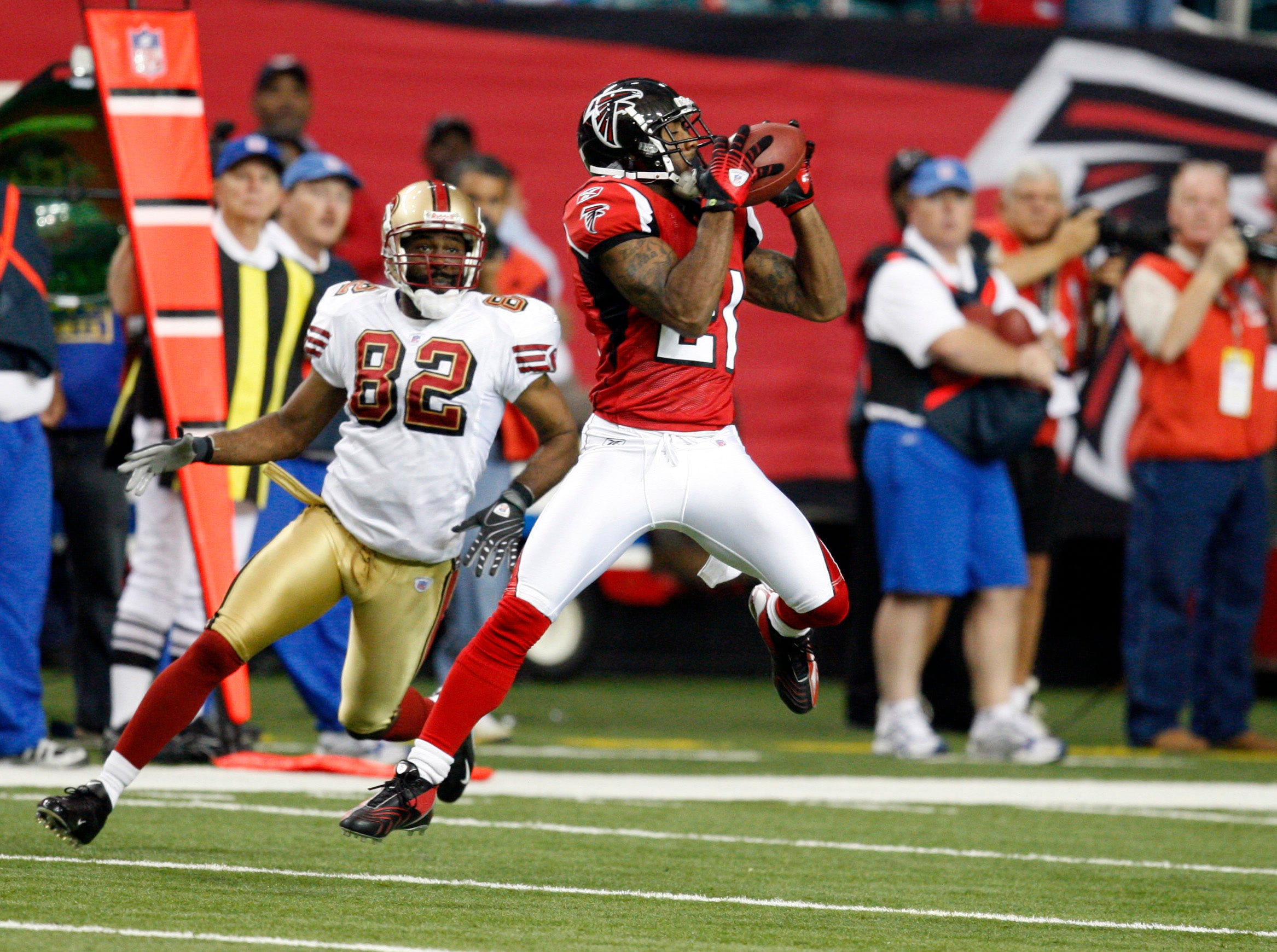 Atlanta Falcons cornerback DeAngelo Hall intercepts a pass in front of San Francisco 49ers wide receiver Darrell Jackson.