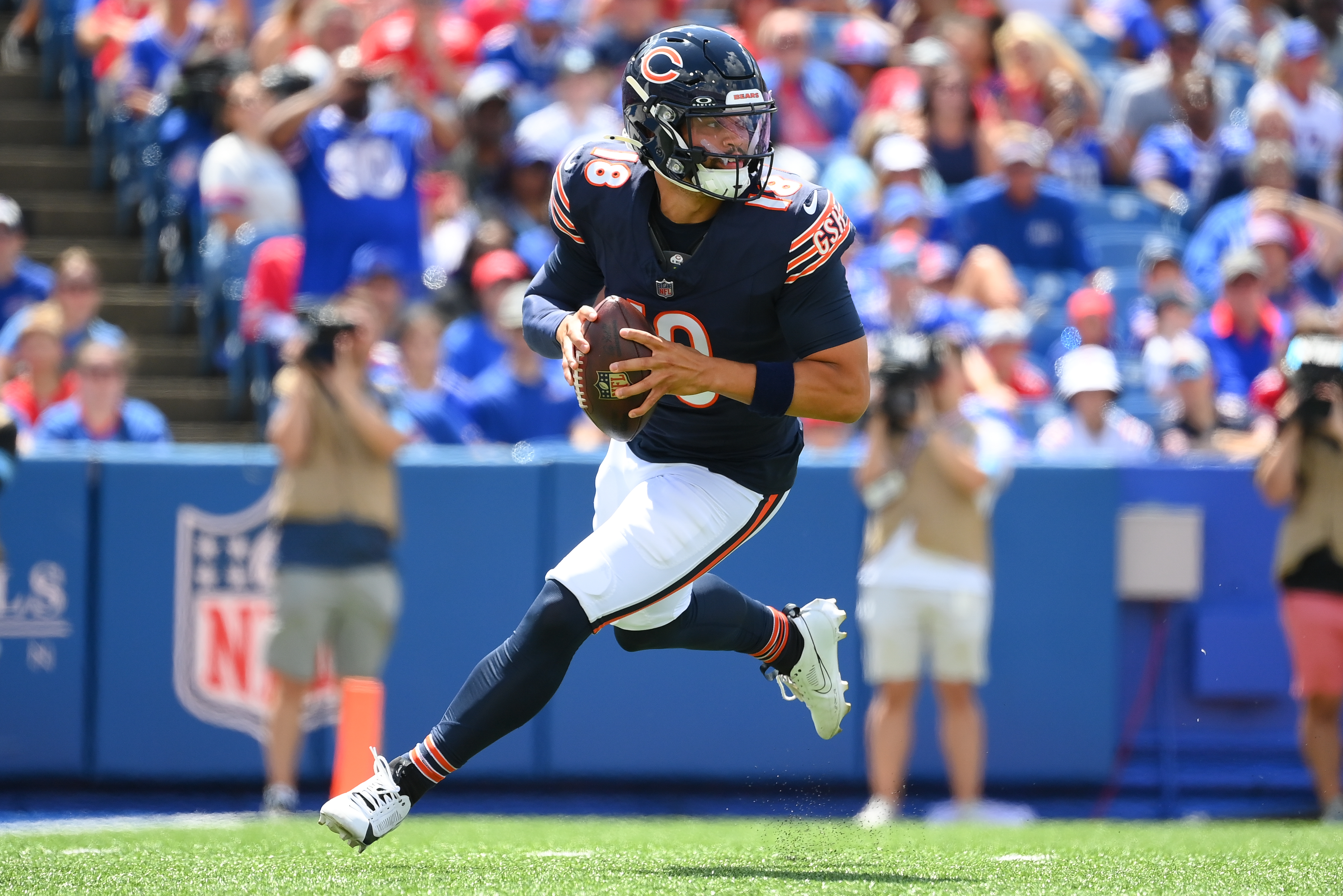 ORCHARD PARK, NEW YORK - AUGUST 10: Caleb Williams #18 of the Chicago Bears rolls out against the Buffalo Bills during the first half of a preseason game at Highmark Stadium on August 10, 2024 in Orchard Park, New York. (Photo by Rich Barnes/Getty Images)