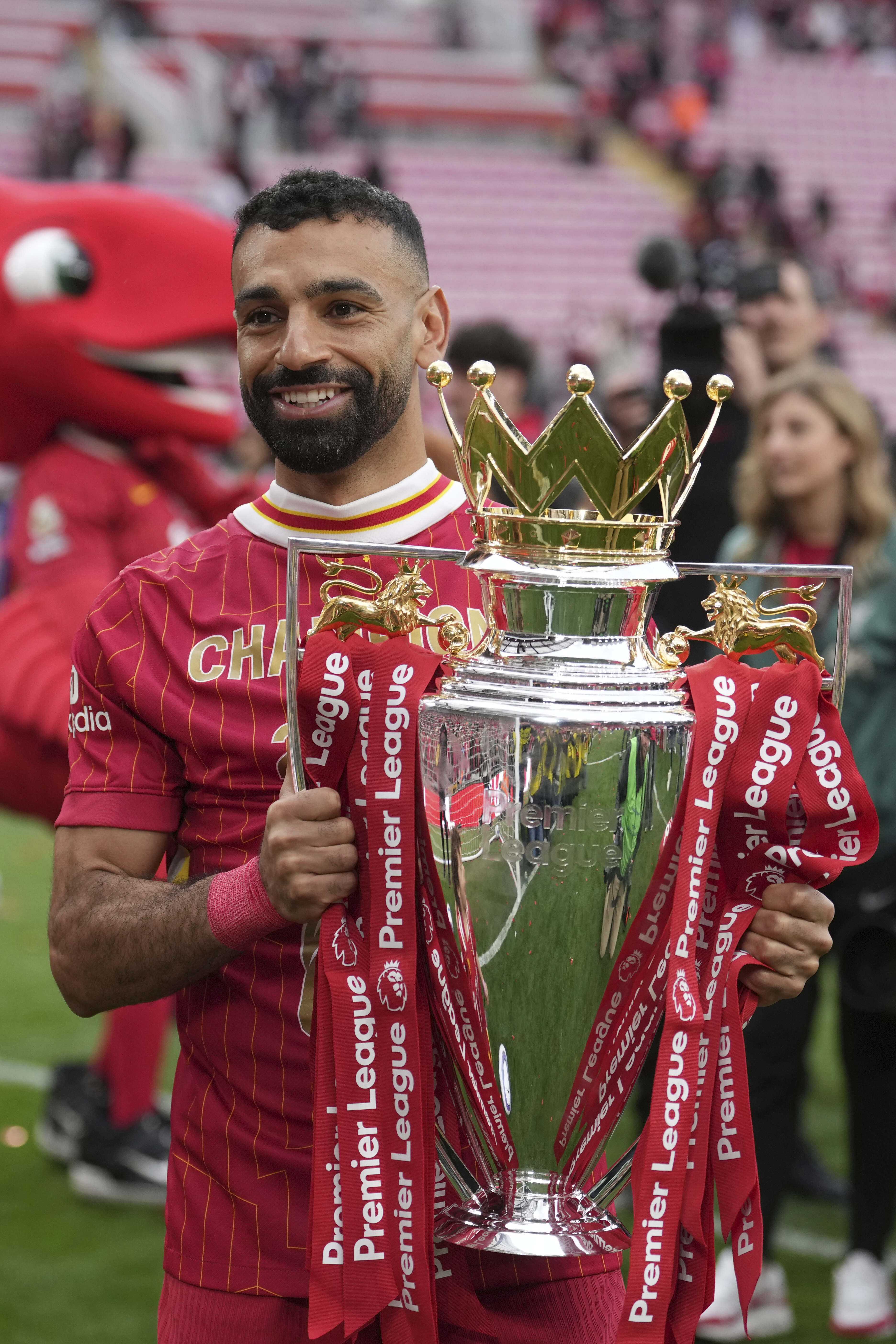 Liverpool's Mohamed Salah poses with the winner's trophy after the English Premier League soccer match between Liverpool and Crystal Palace at the Anfield stadium in Liverpool, England, Sunday, May 25, 2025. (AP Photo/Jon Super)