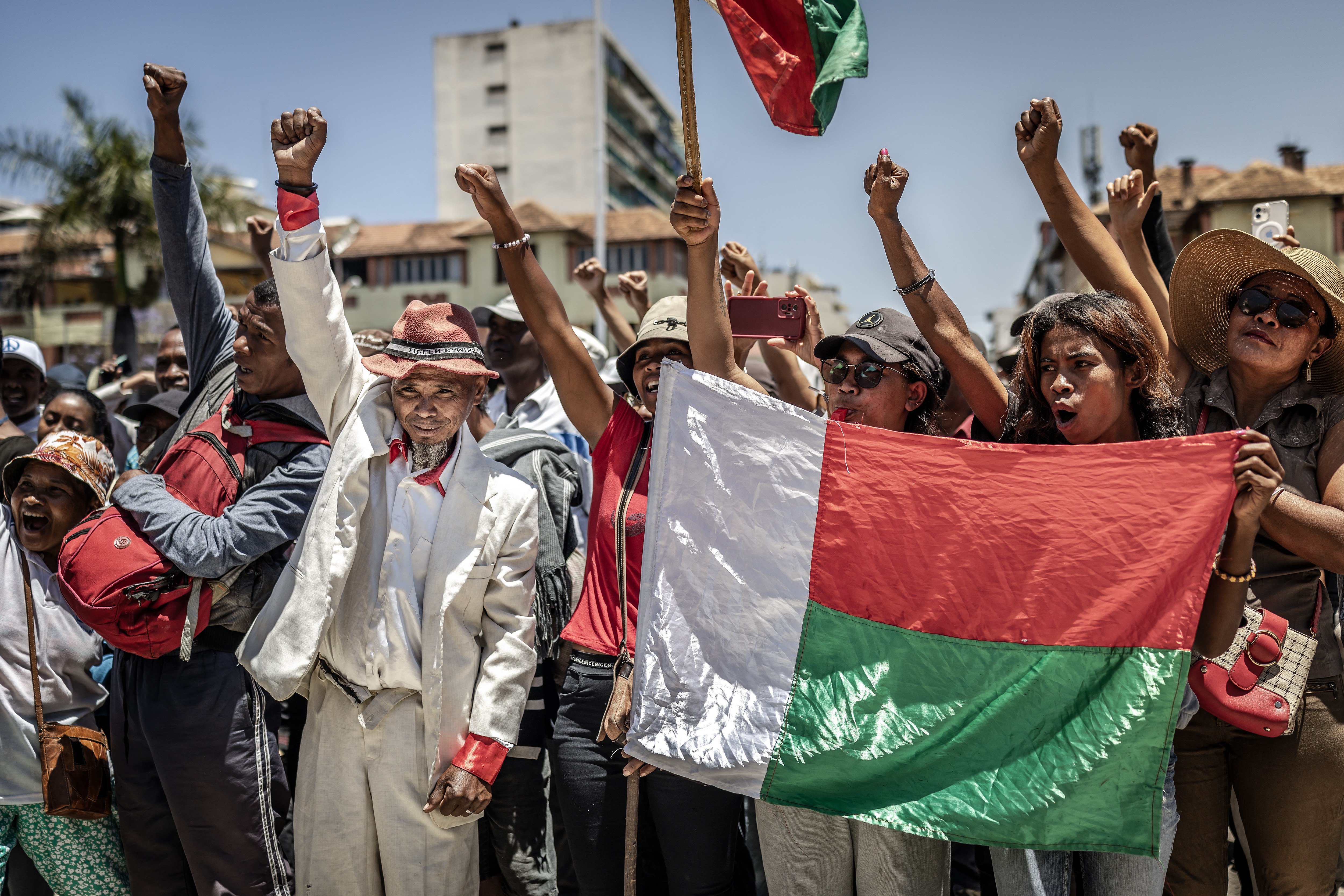 TOPSHOT - Residents and protesters hold Malagasy flags and chant slogans as they gather for a civil society rally demanding the resignation of President Andry Rajoelina in Antananarivo, on October 14, 2025.